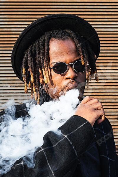Black man with dreadlocks wearing hat 